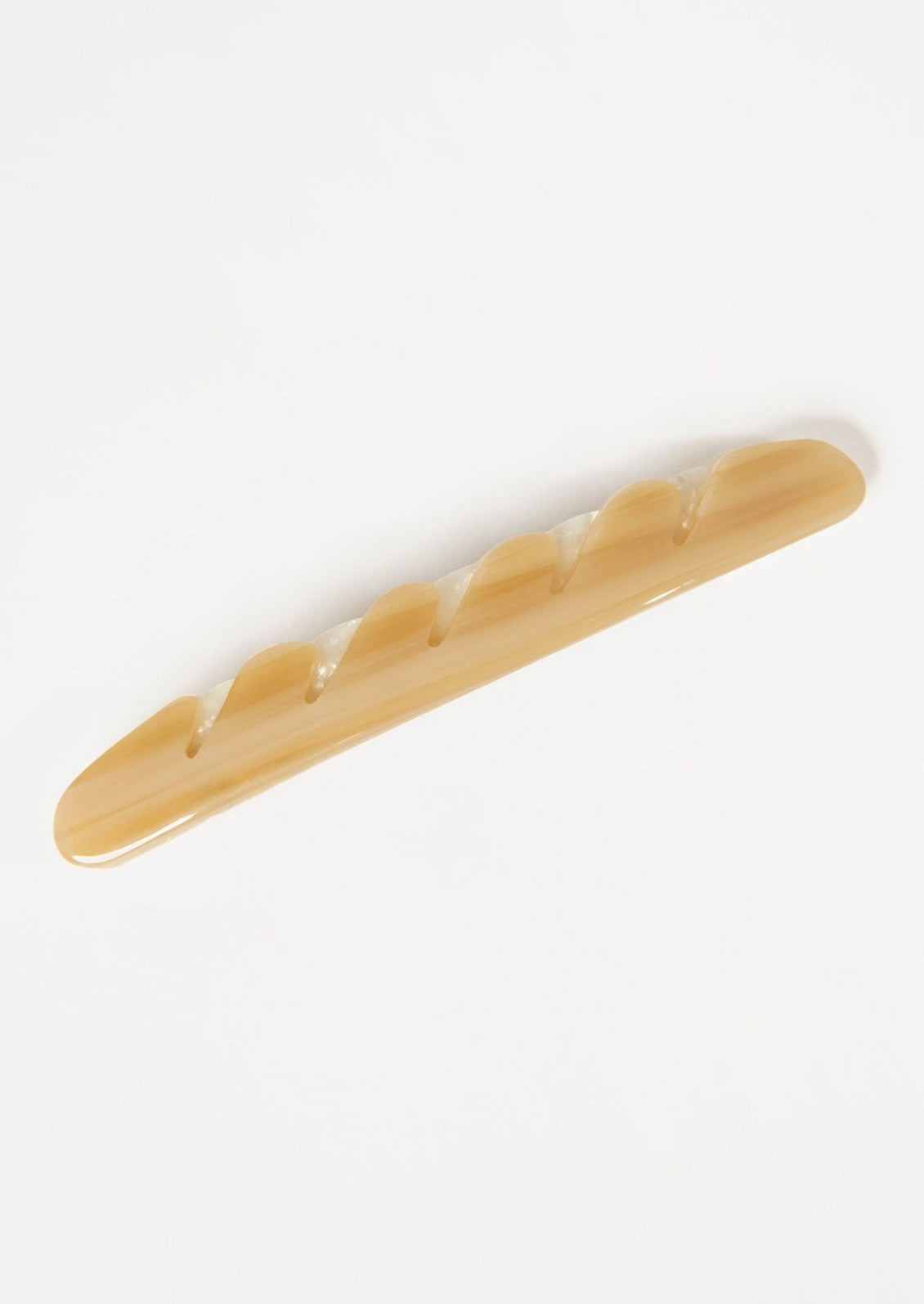 A baguette hair clip in light brown.
