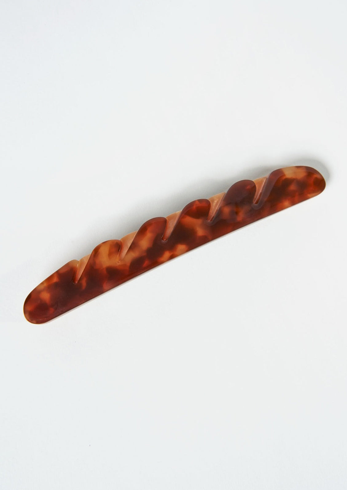 A baguette hair clip in dark brown.