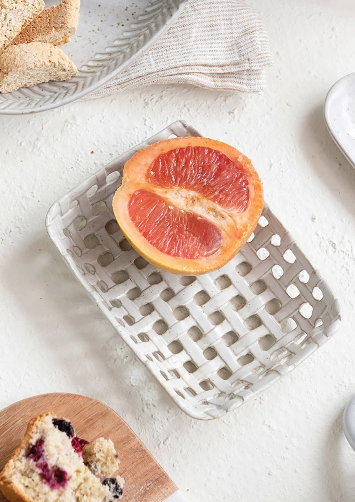 A rectangular shaped ceramic tray with open basketweave design.