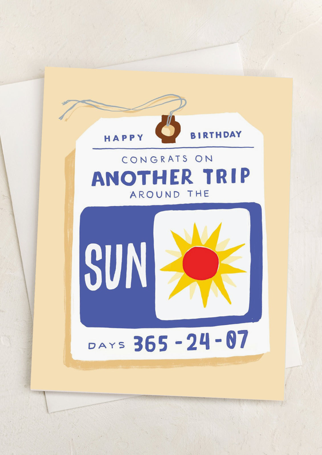 A greeting card with illustration of travel ticket, text reads "Happy Birthday - Congrats on another trip around the sun".