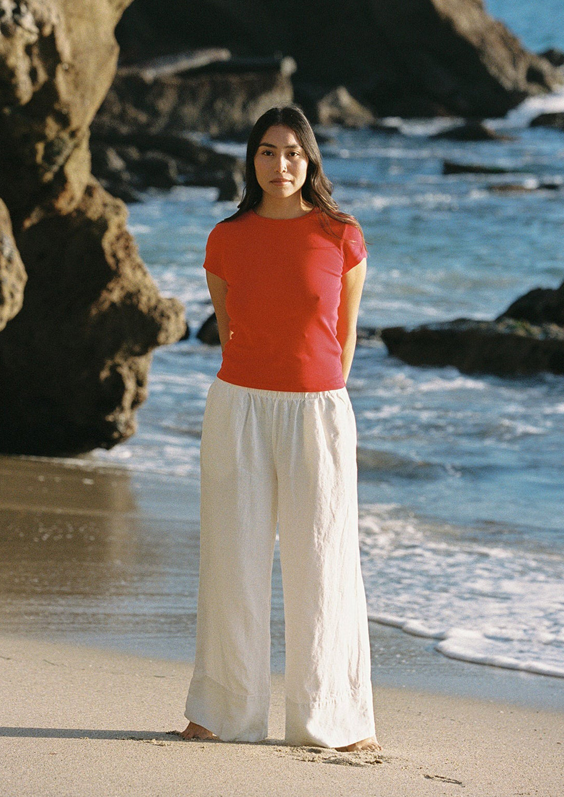 A woman wearing a red short sleeve tee.