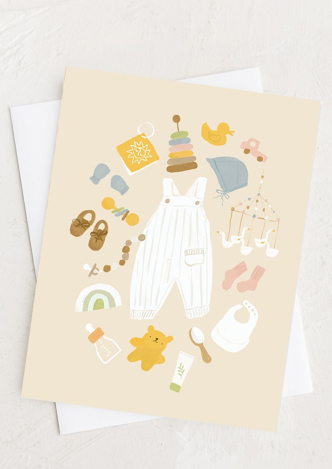 A pastel colored greeting card with baby items illustration.