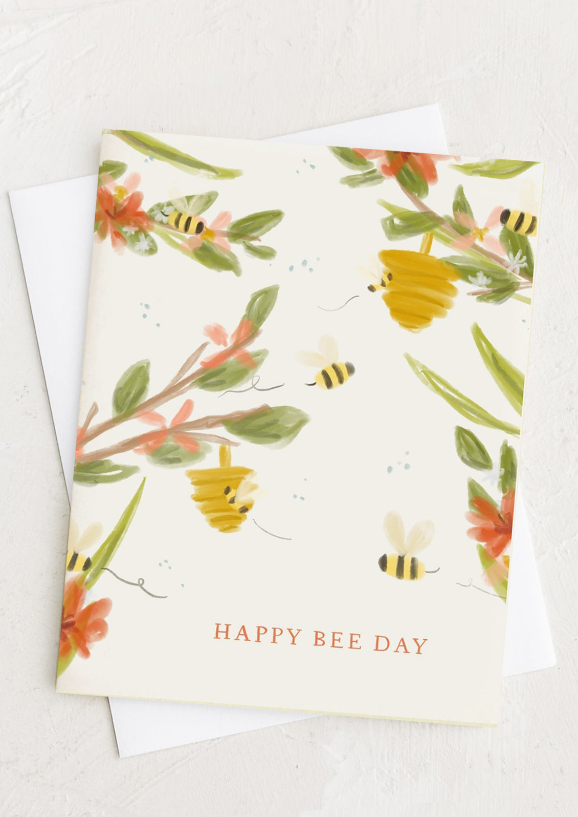 A card with illustrated bees and beehive print, text reads "Happy Bee Day".
