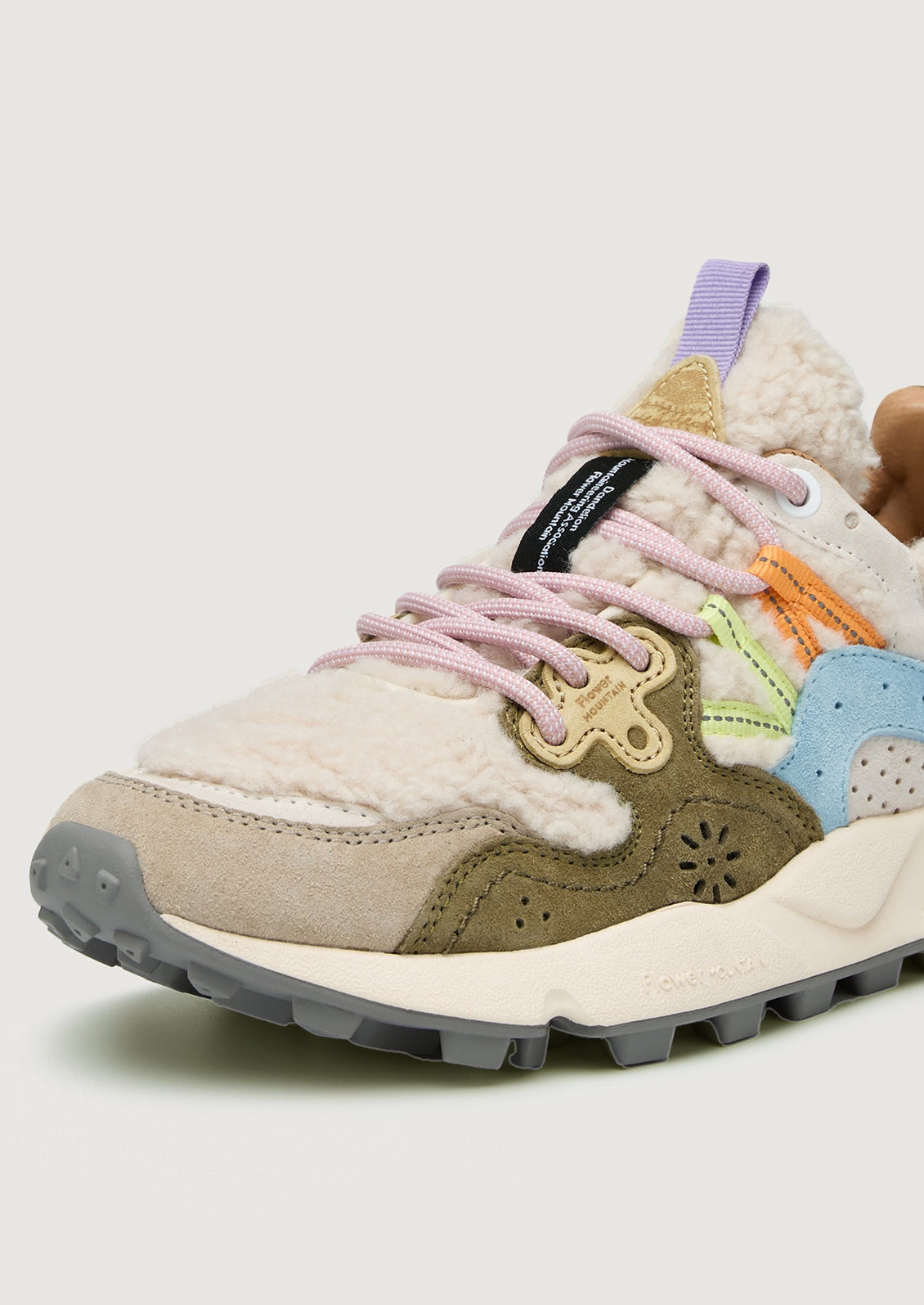 A pair of sporty sneakers in pastel multicolor with cream shearling upper.