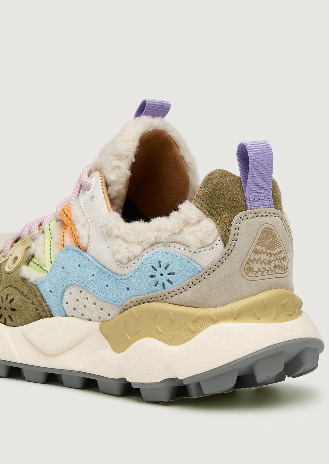 A pair of sporty sneakers in pastel multicolor with cream shearling upper.