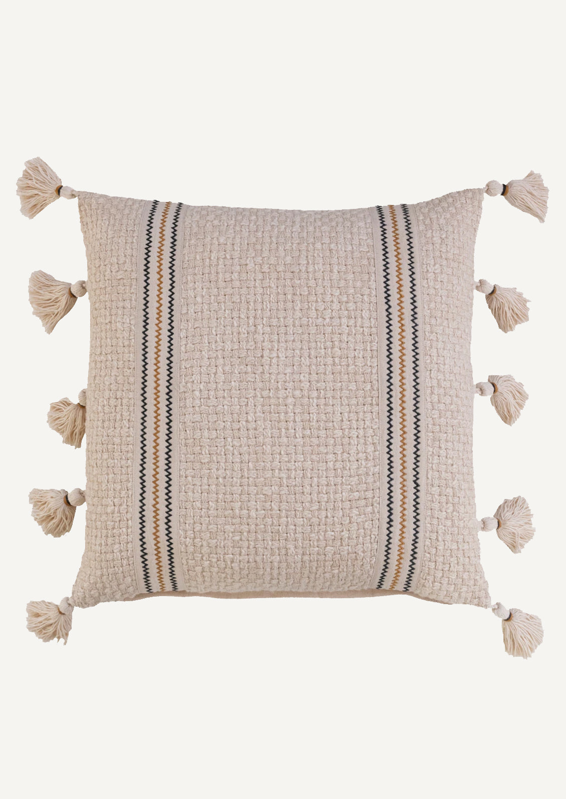 A natural cream colored pillow with weave texture, two zig zag stripes in black and ochre, and tassels at sides.