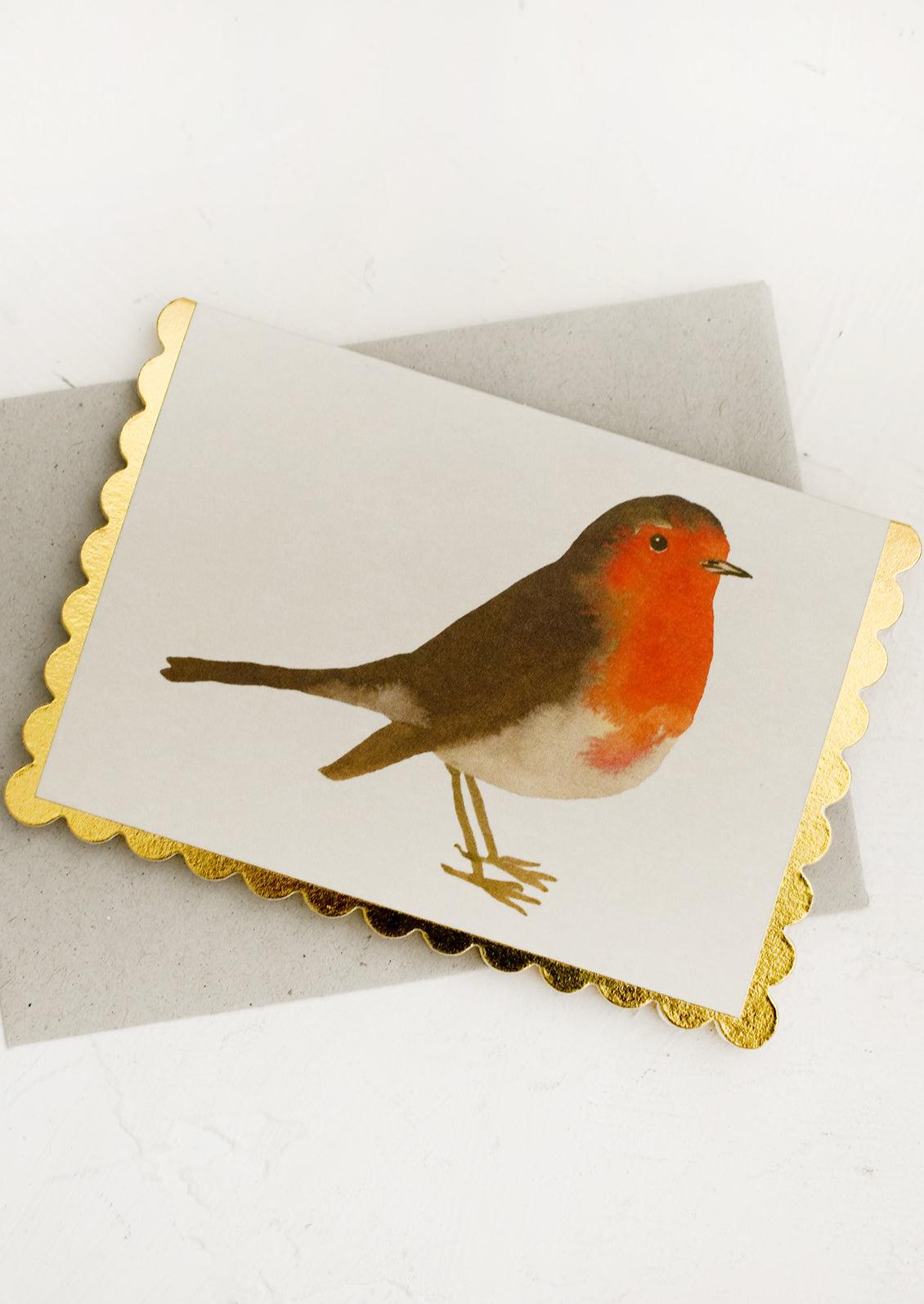 A scalloped edge greeting card with robin.