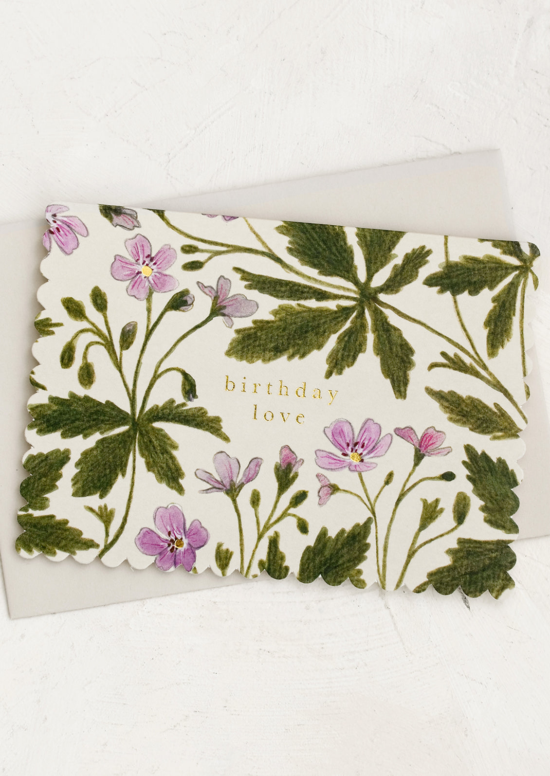 A geranium floral print card with text reading "Birthday love".