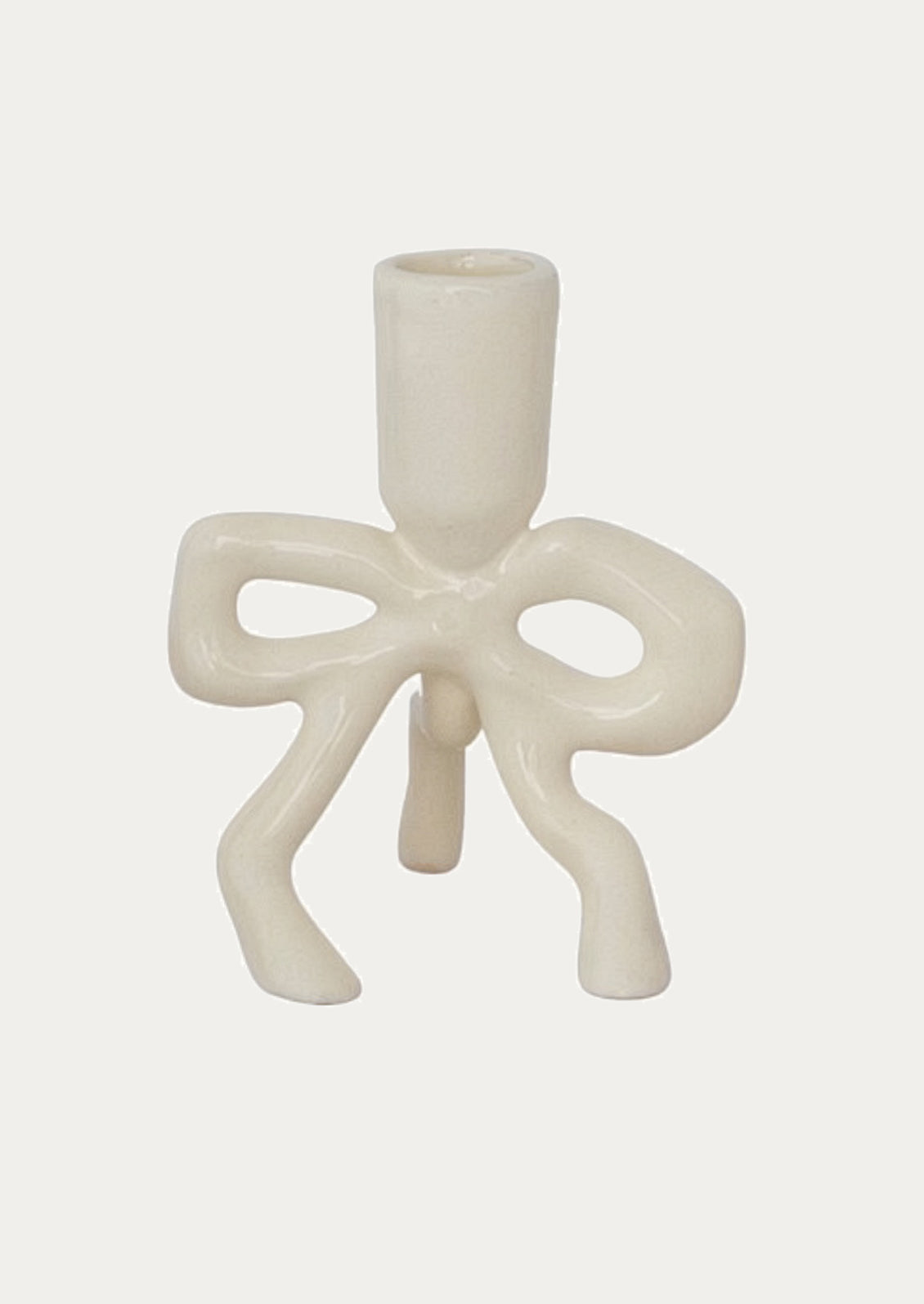 White enamel candle holder with bow design on a white background