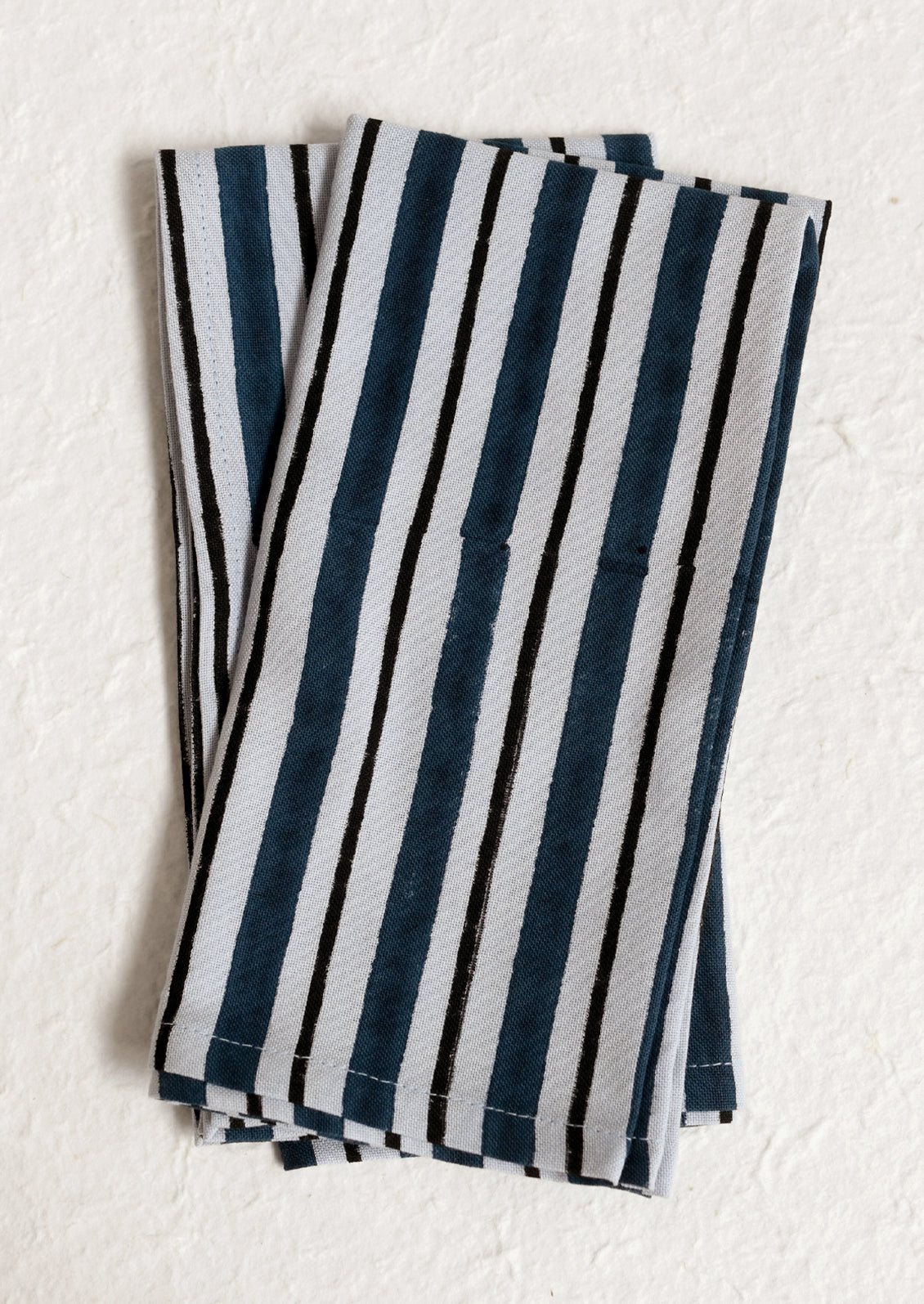 A pair of cotton napkins in blue and navy stripe.