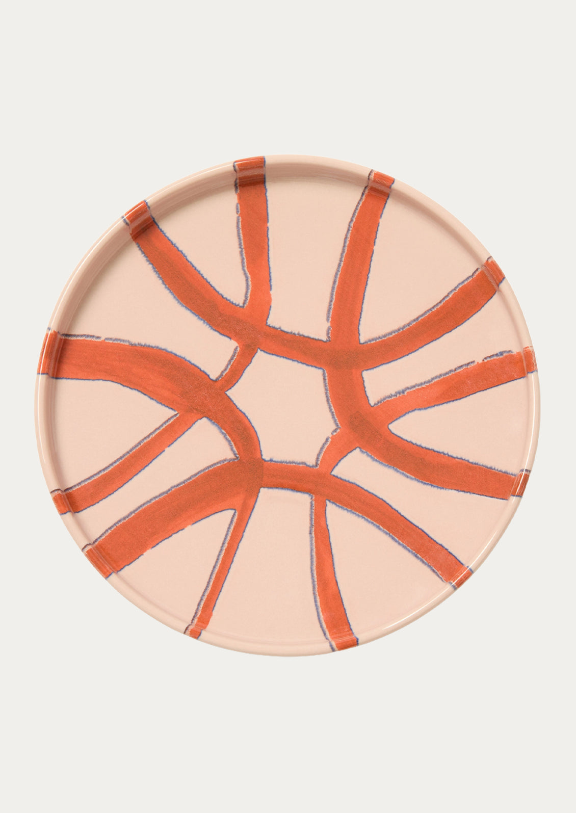 A ceramic side plate with an abstract design in a blush pink color.