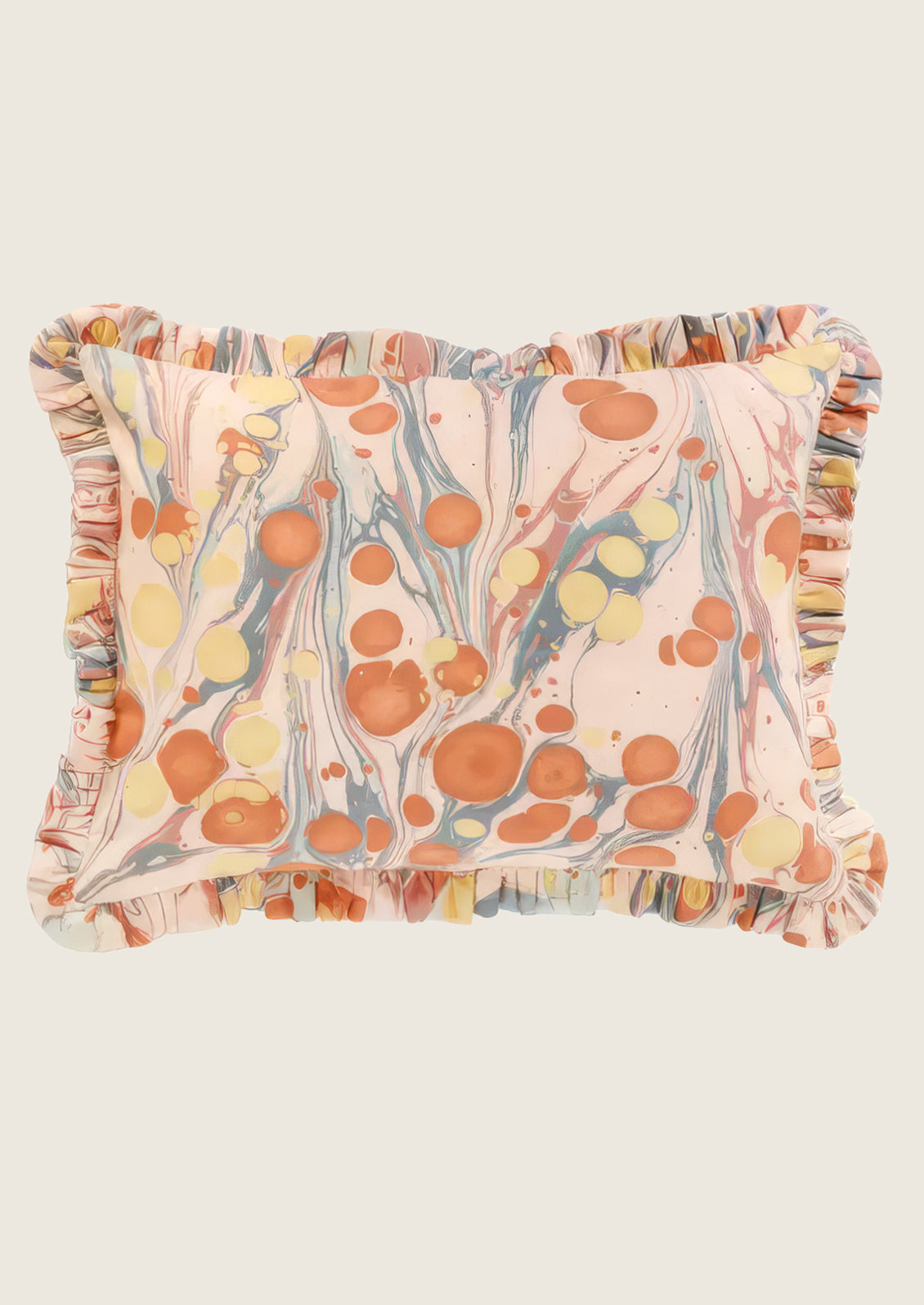 Decorative pillow with marbleized pattern and ruffled edges on a white background