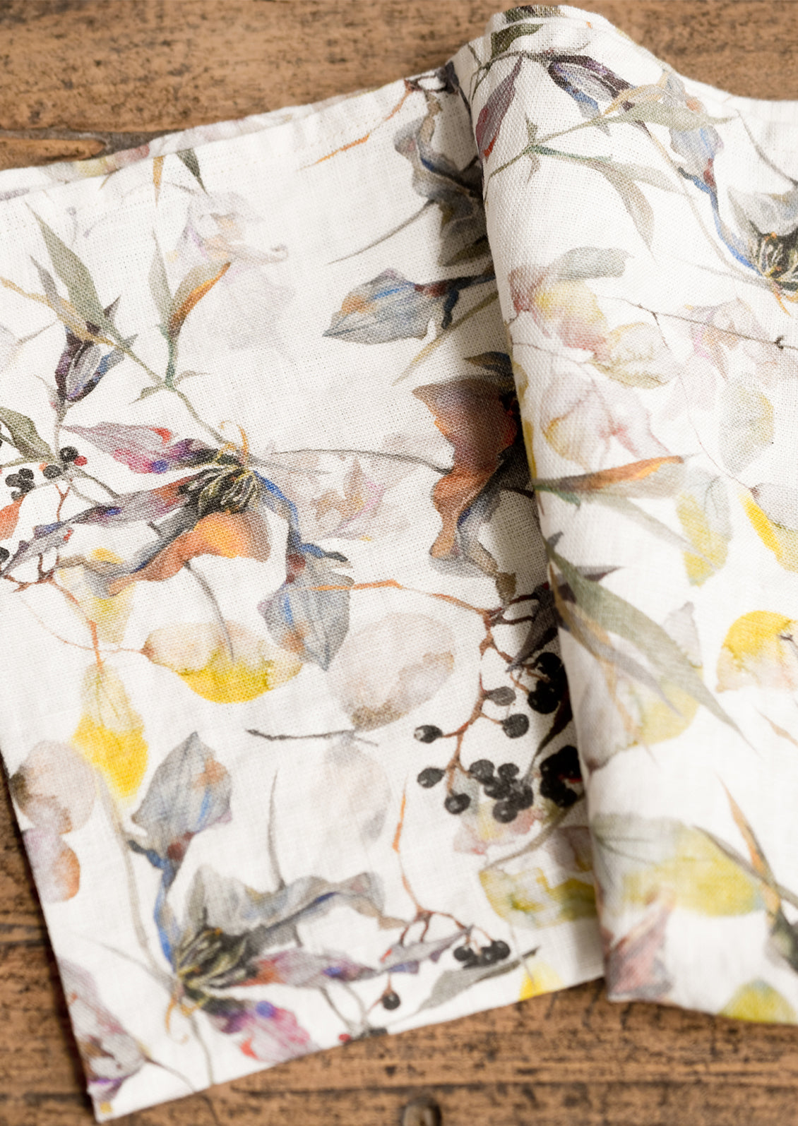 A botanically printed cream linen tea towel.
