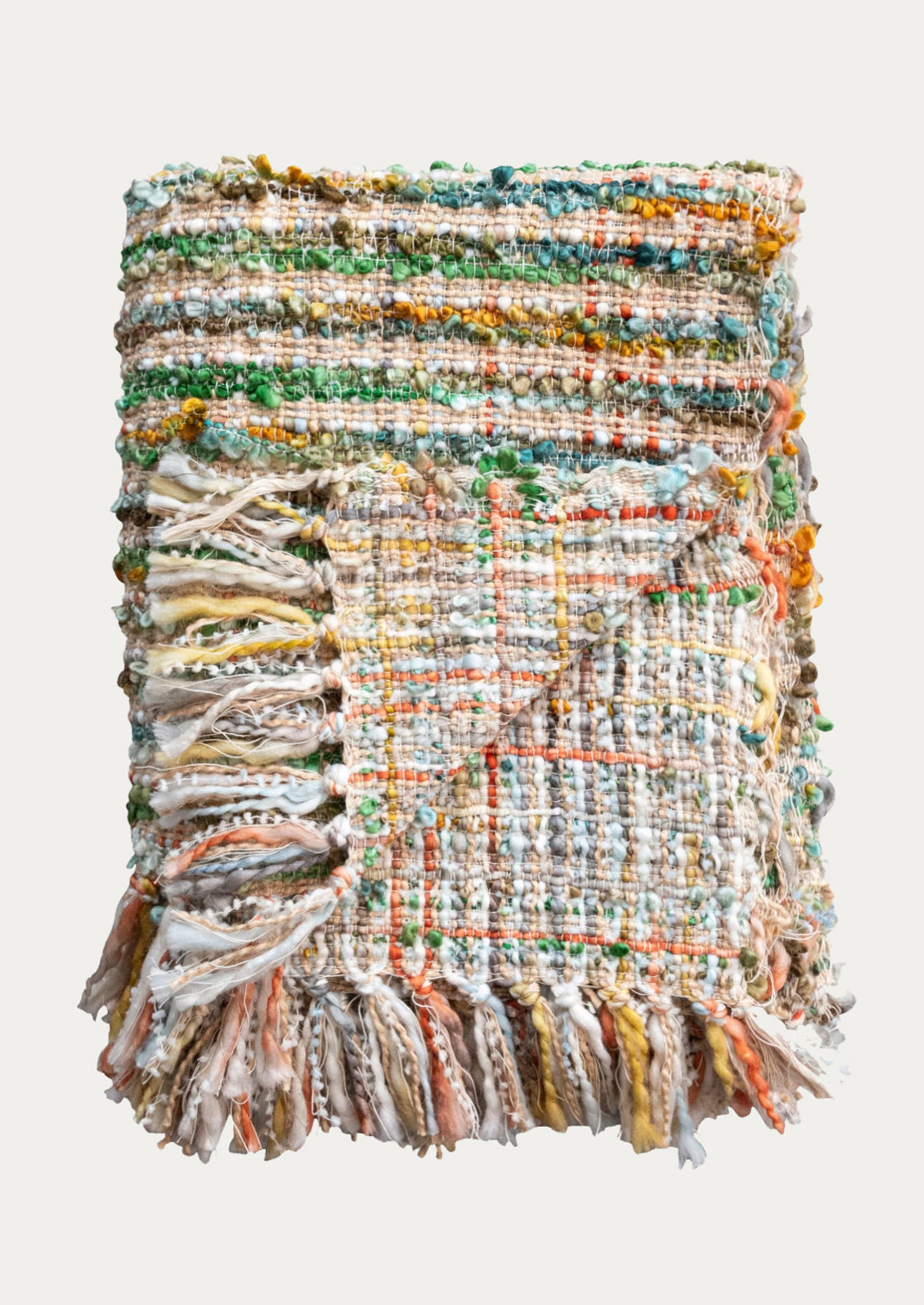 A throw blanket in multicolor boucle tweed.