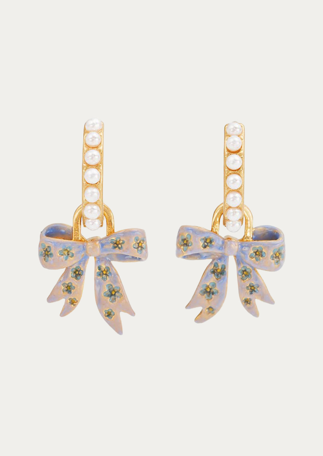 A pair of gold hoop earrings adorned with faux pearls and a bow charm.