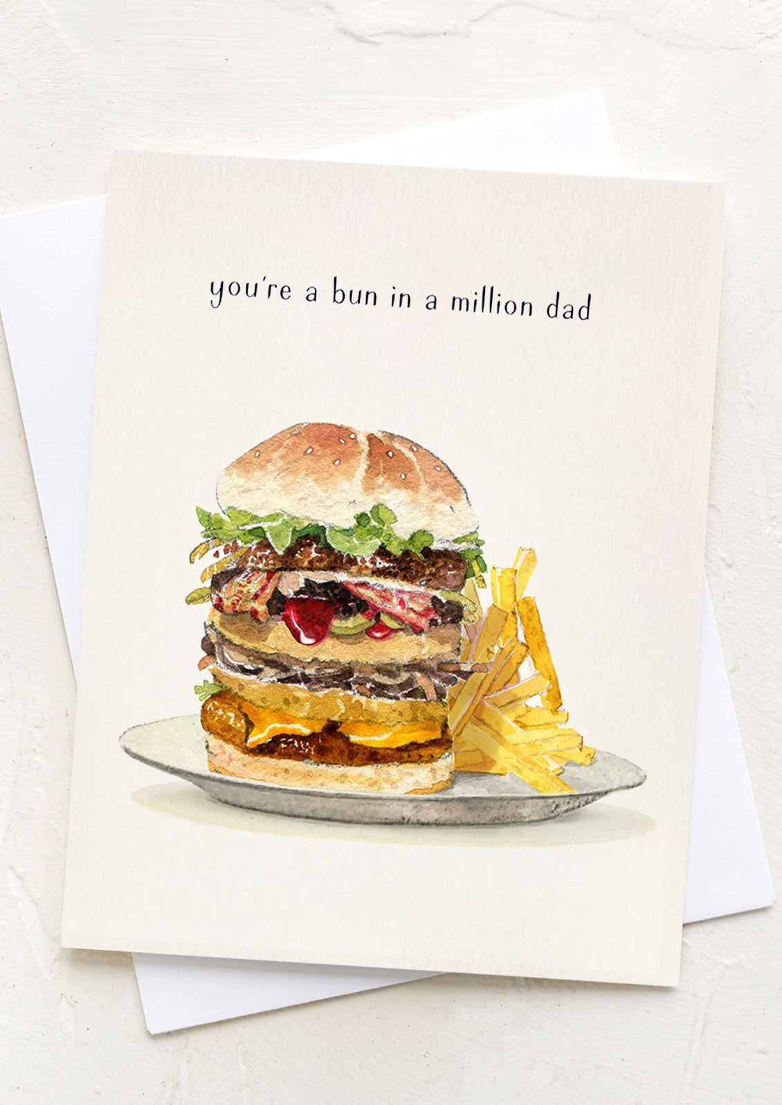 A greeting card with image of hamburger, text reads "You're a bun in a million Dad".