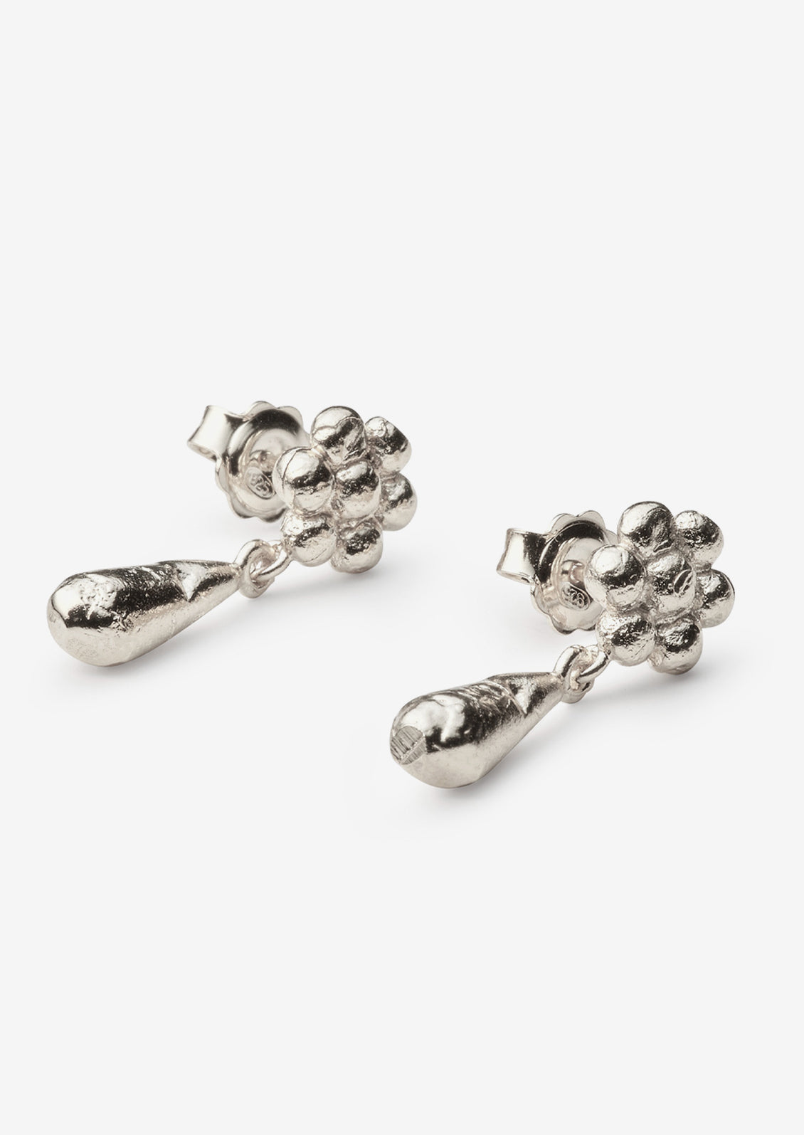A pair of silver earrings with flower post and teardrop charm.