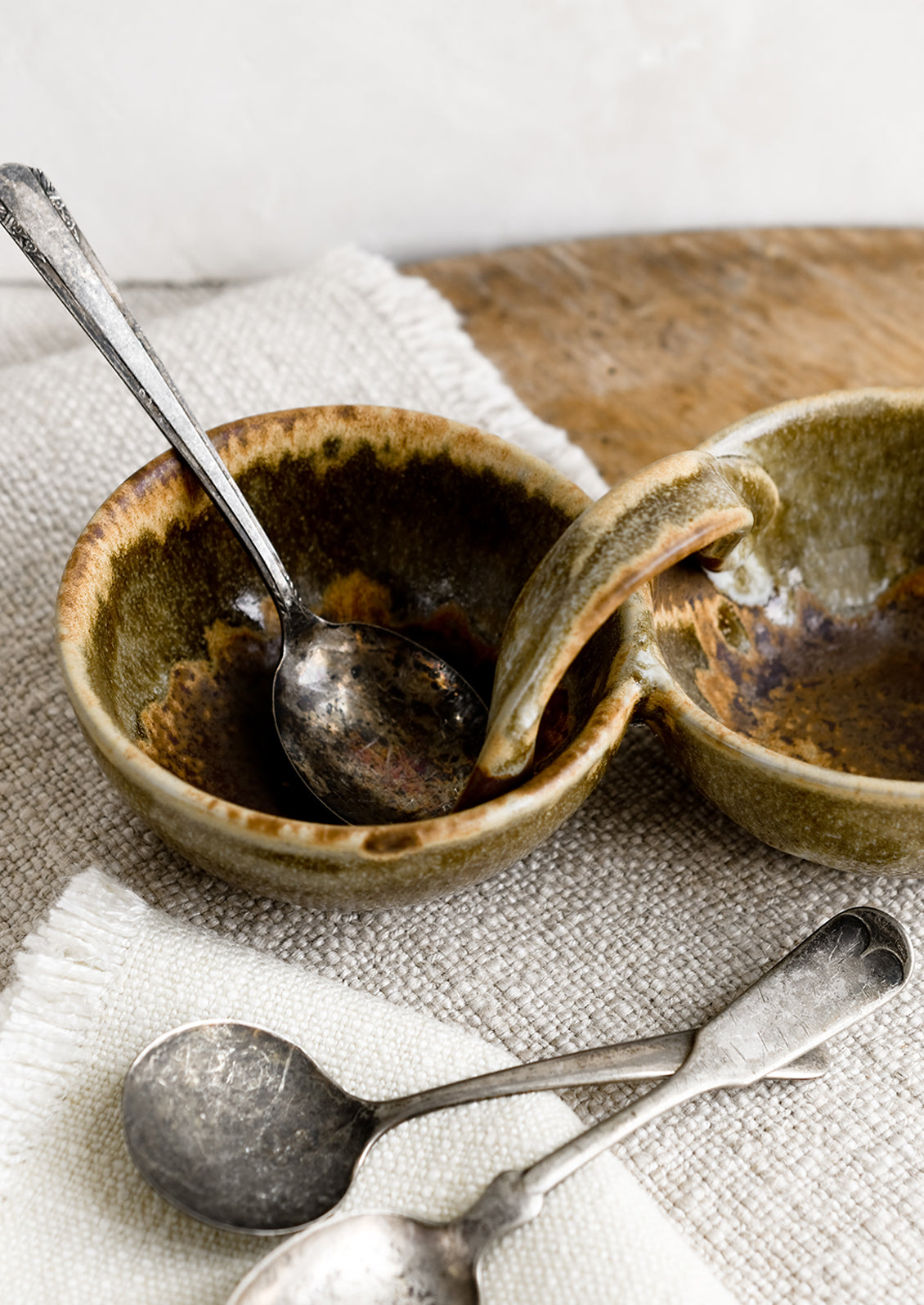 A double cellar ceramic vessel in variegated brown glaze.