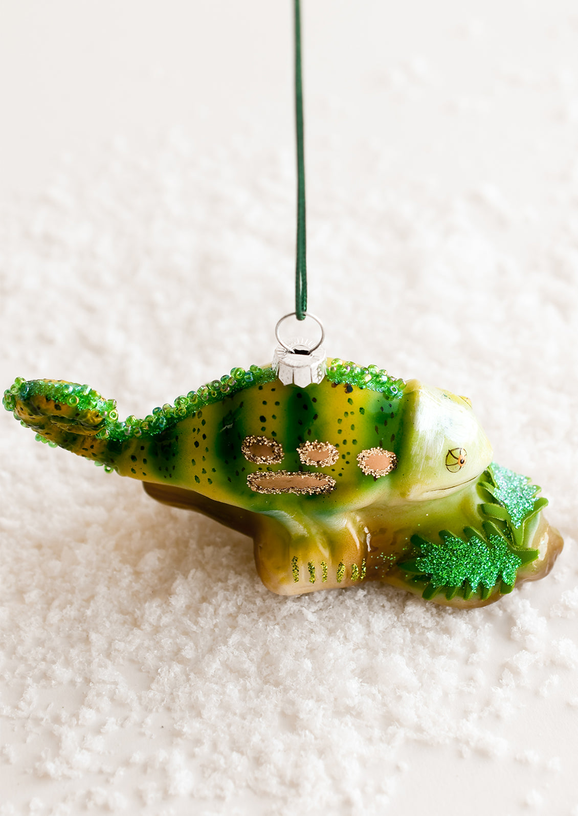 A glass ornament of a chameleon.