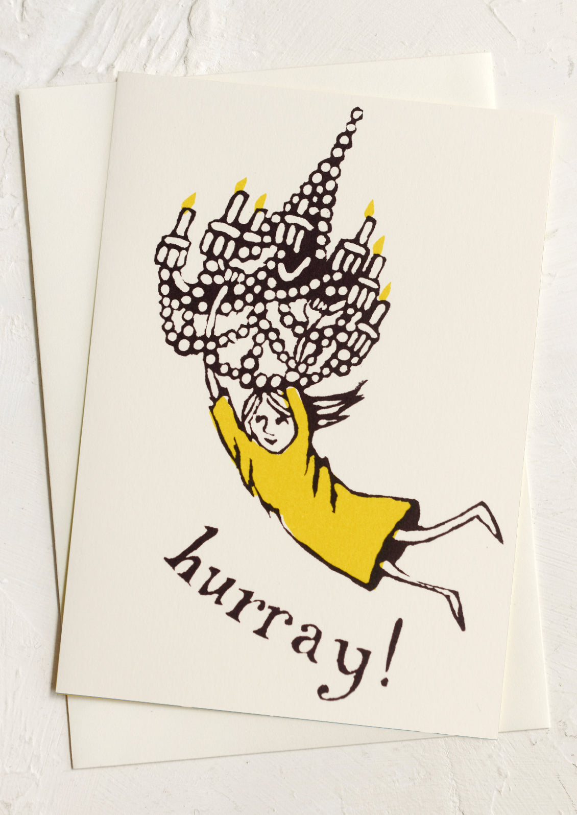 A greeting card with illustration of girl swinging from chandelier, text reads "Hurray!".