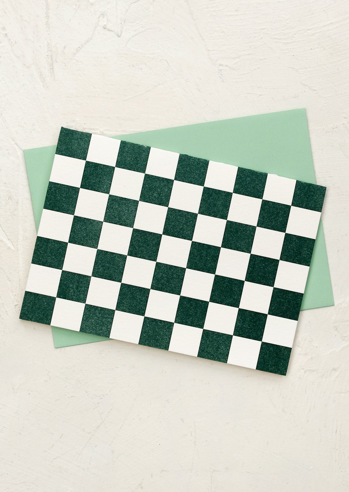 A set of cards in green and white checker pattern.