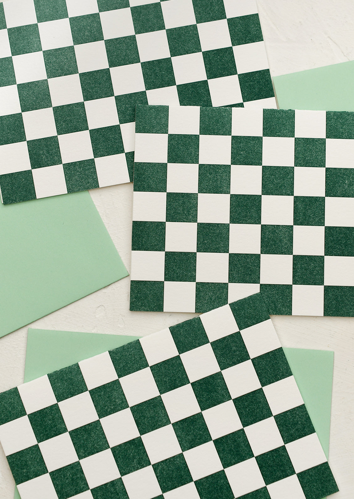 A set of cards in green and white checker pattern.