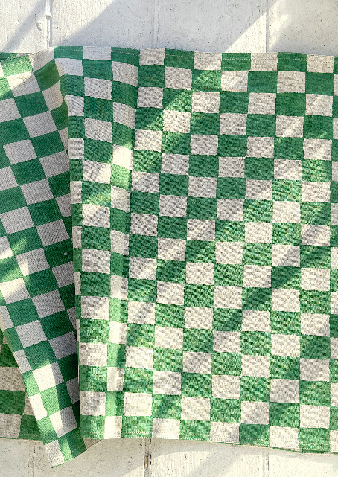 A linen table runner in clover green checker print.