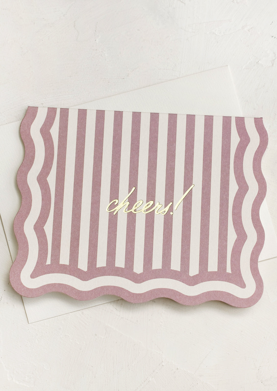 A diecut card with purple lawn stripe reading "Cheers!".