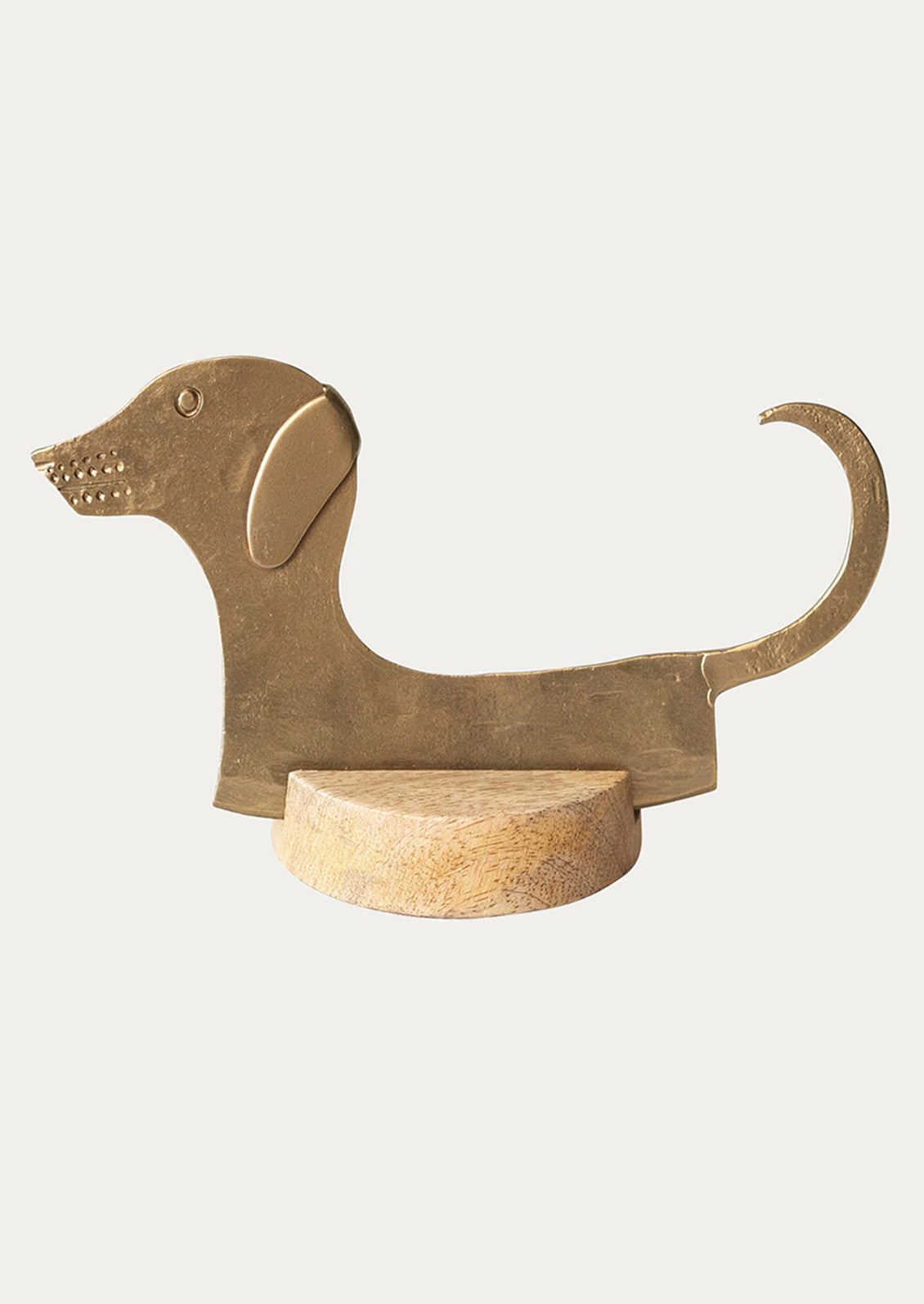 Brass dog-shaped cheese blade on a white background