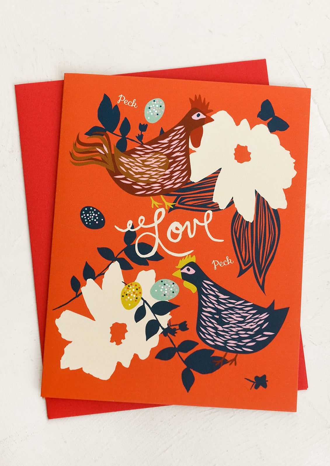 A card with illustrations of chickens and flowers, small text reads "Peck LOVE peck".