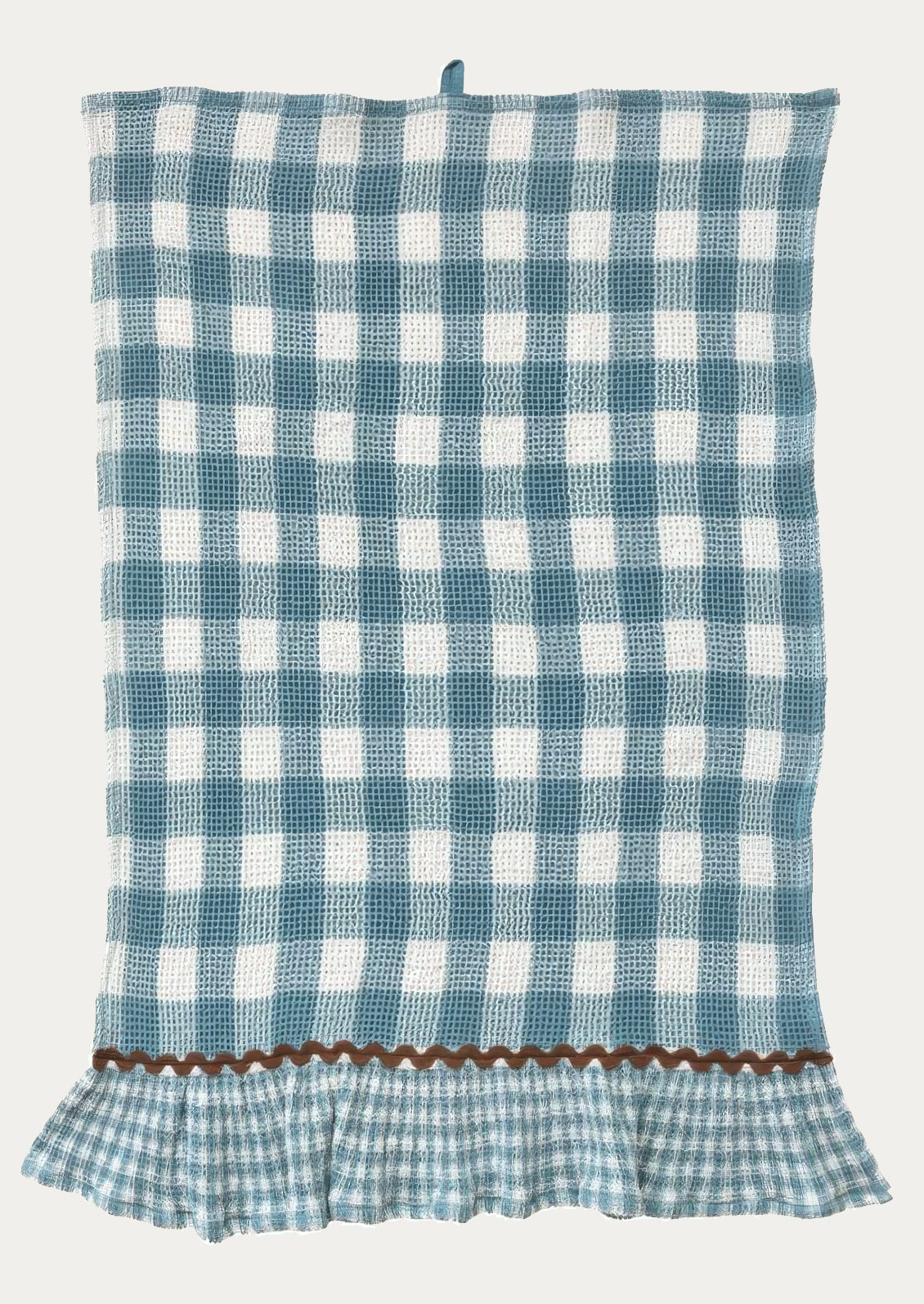 A waffle textured tea towel in blue gingham pattern, ruffle at bottom in smaller scale gingham with contrast ric rac trim.