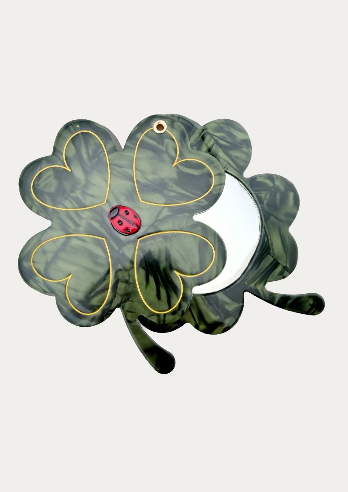 Four-leaf clover-shaped mirror with a ladybug.
