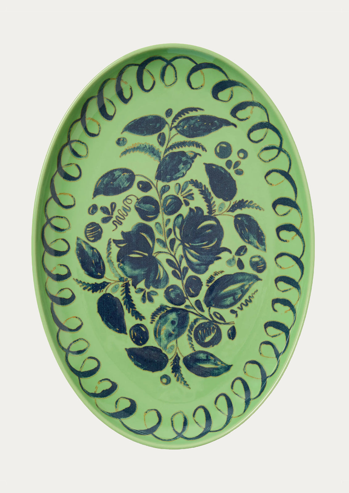 Decorative plate with blue floral pattern on a green background