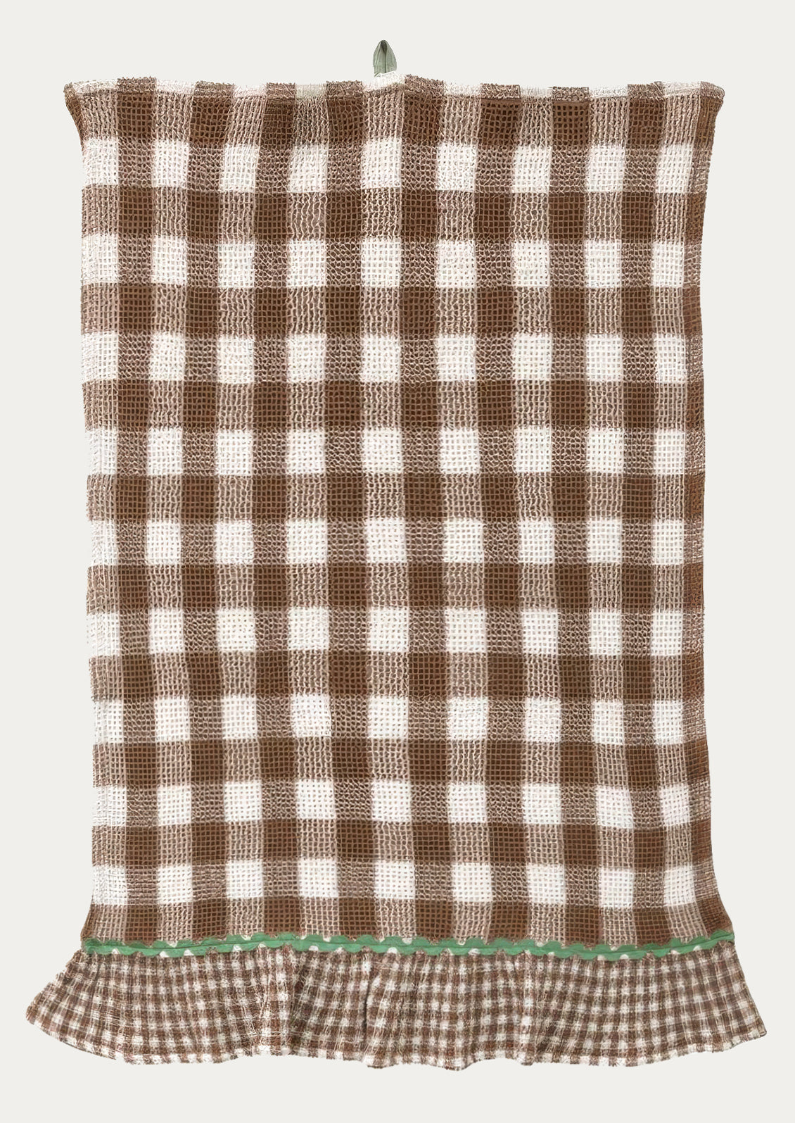 A waffle textured tea towel in brown gingham pattern, ruffle at bottom in smaller scale gingham with contrast ric rac trim.