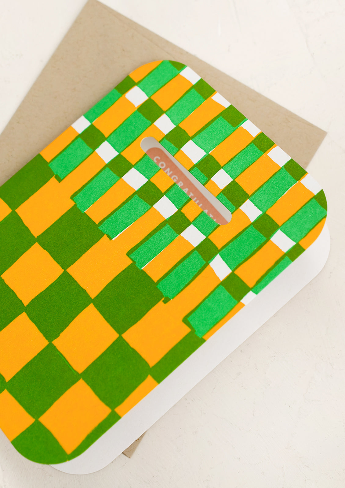 A checkboard print card in yellow and green reading "Congratulations!'.