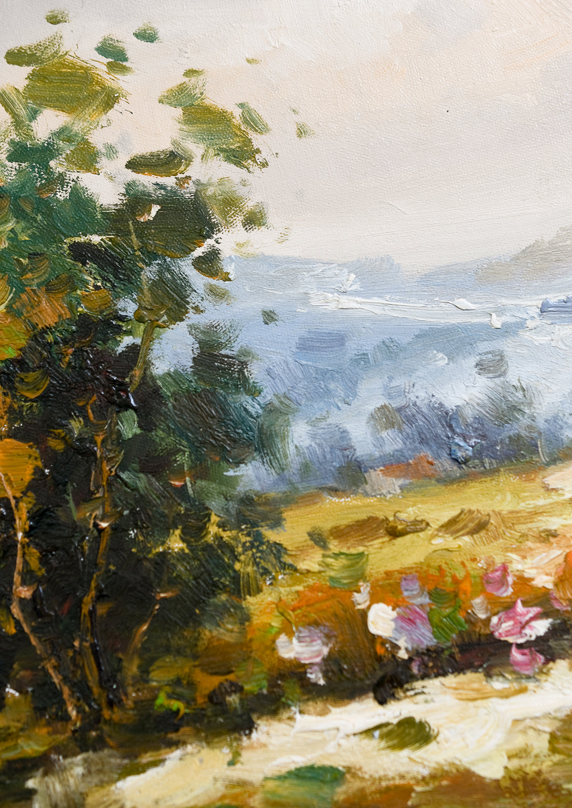 A framed original oil painting of countryside landscape.
