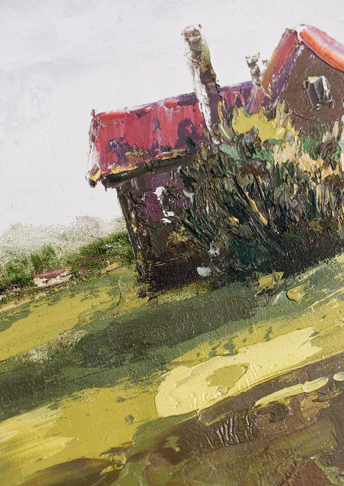 An original framed oil painting of a house in the country.