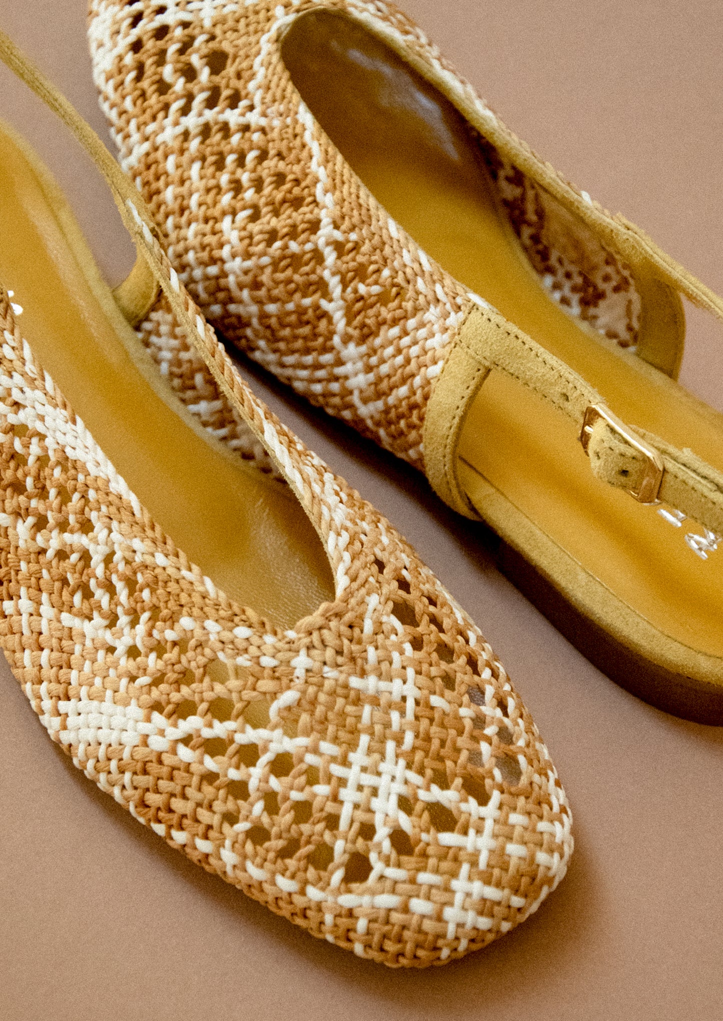 A pair of crochet slingback heeled sandals.
