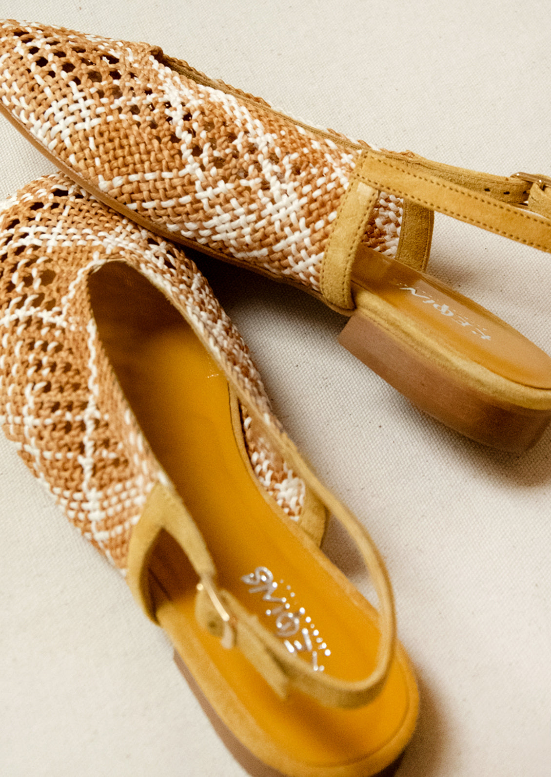 A pair of crochet slingback heeled sandals.