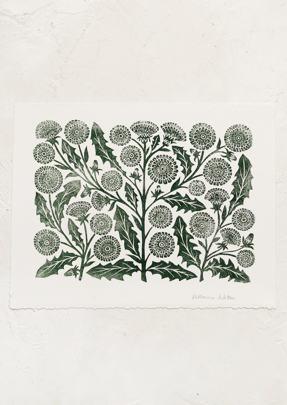A woodblock print of dandelion flowers in dark green ink.