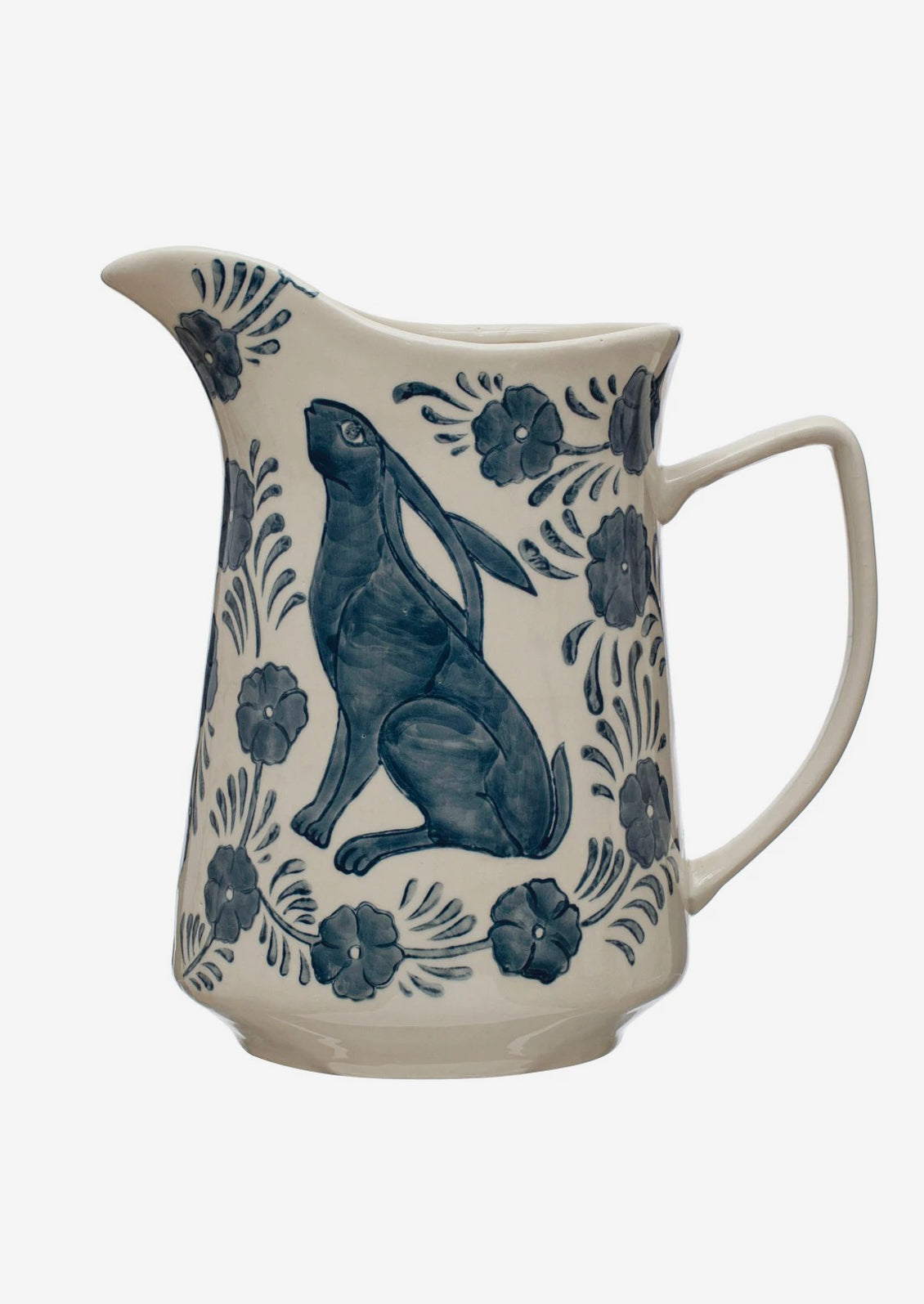 A white ceramic pitcher with blue delft-inspired rabbit and flower pattern.