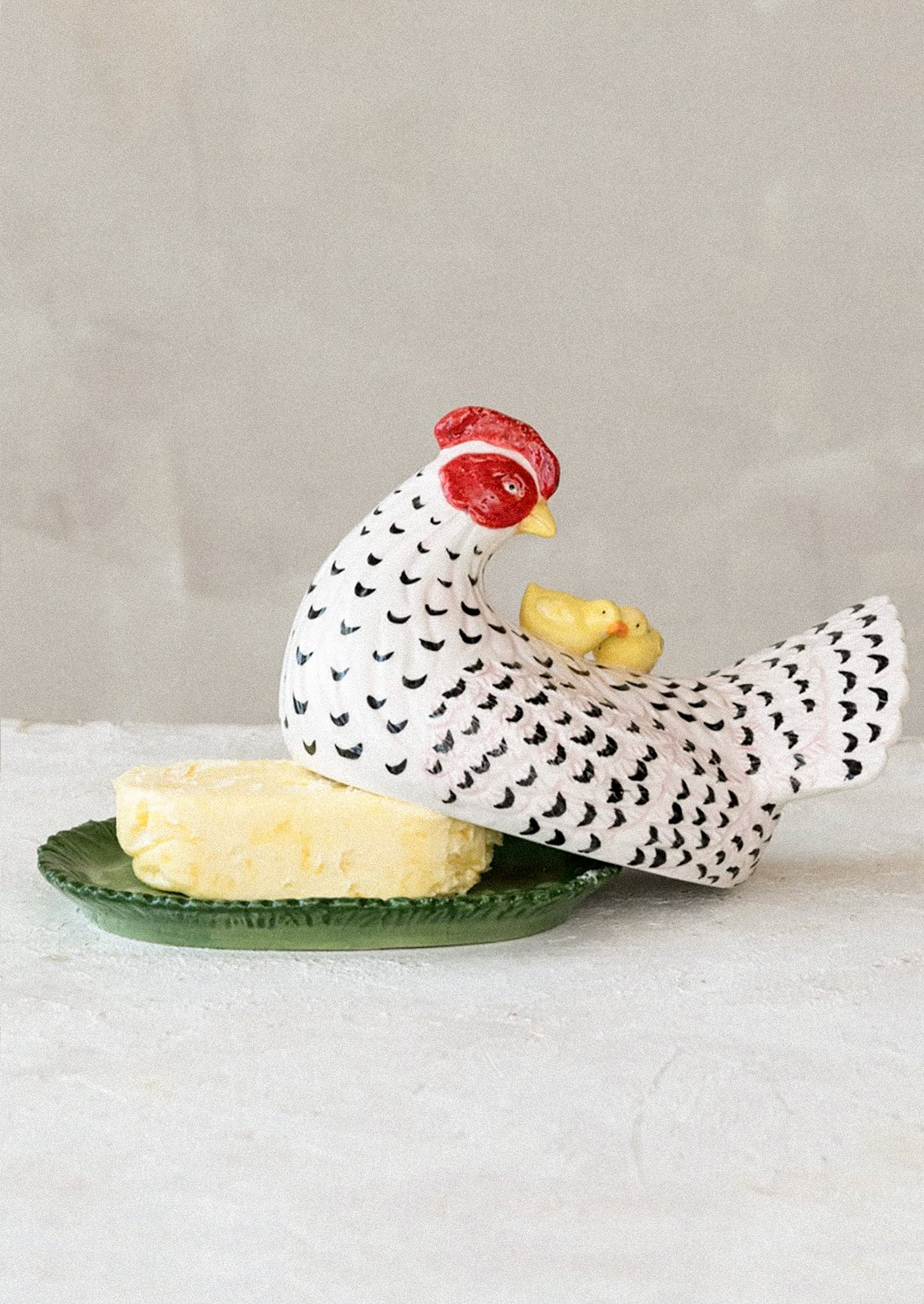 A large butter dish in the shape of a chicken.