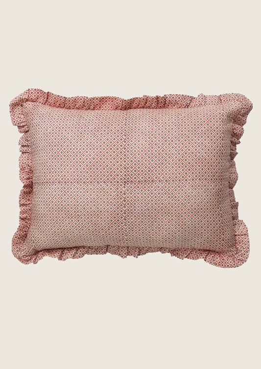 Pink geometric patterned linen pillow with ruffled edges.