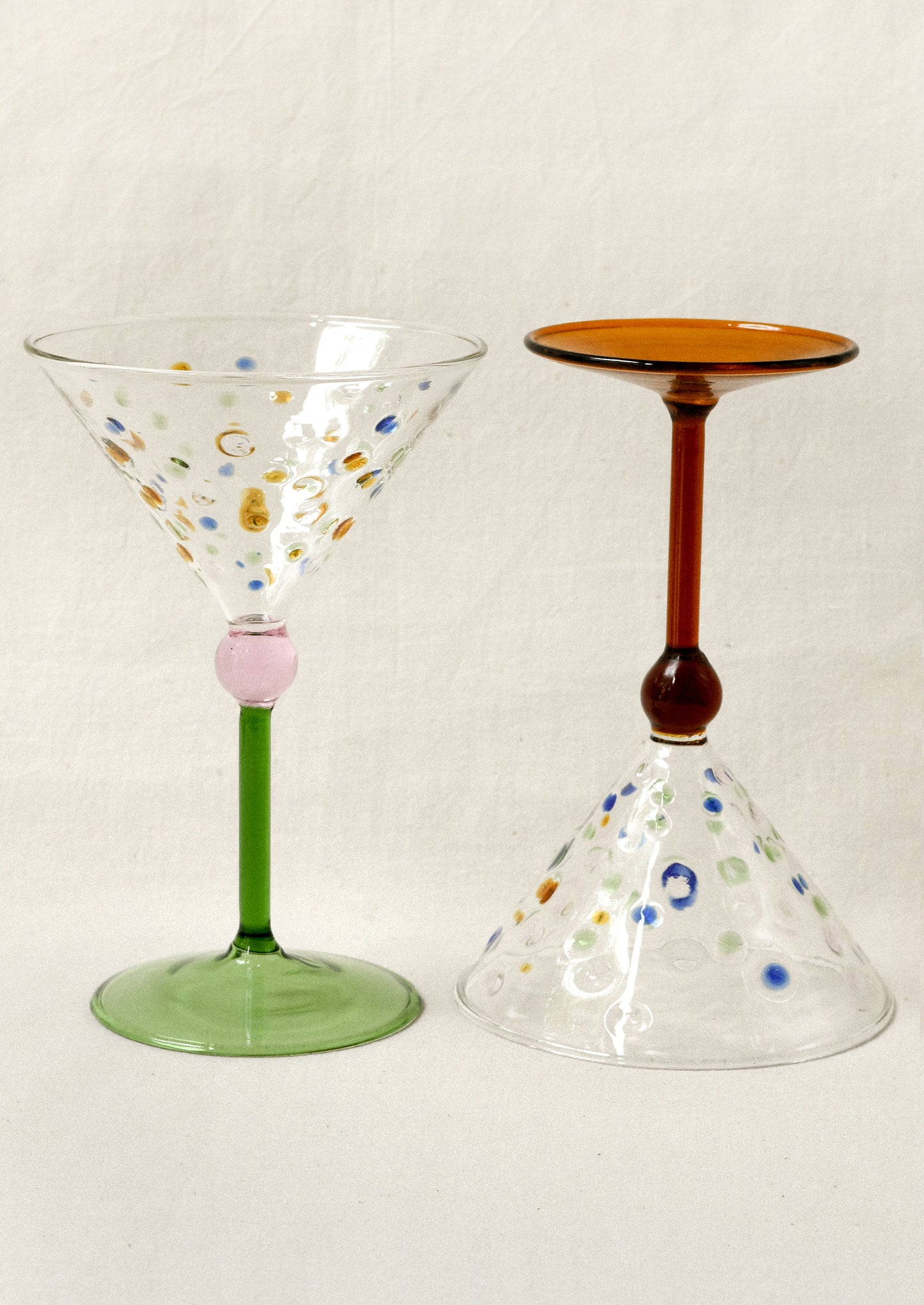 Two hand-painted glassware items on a white background