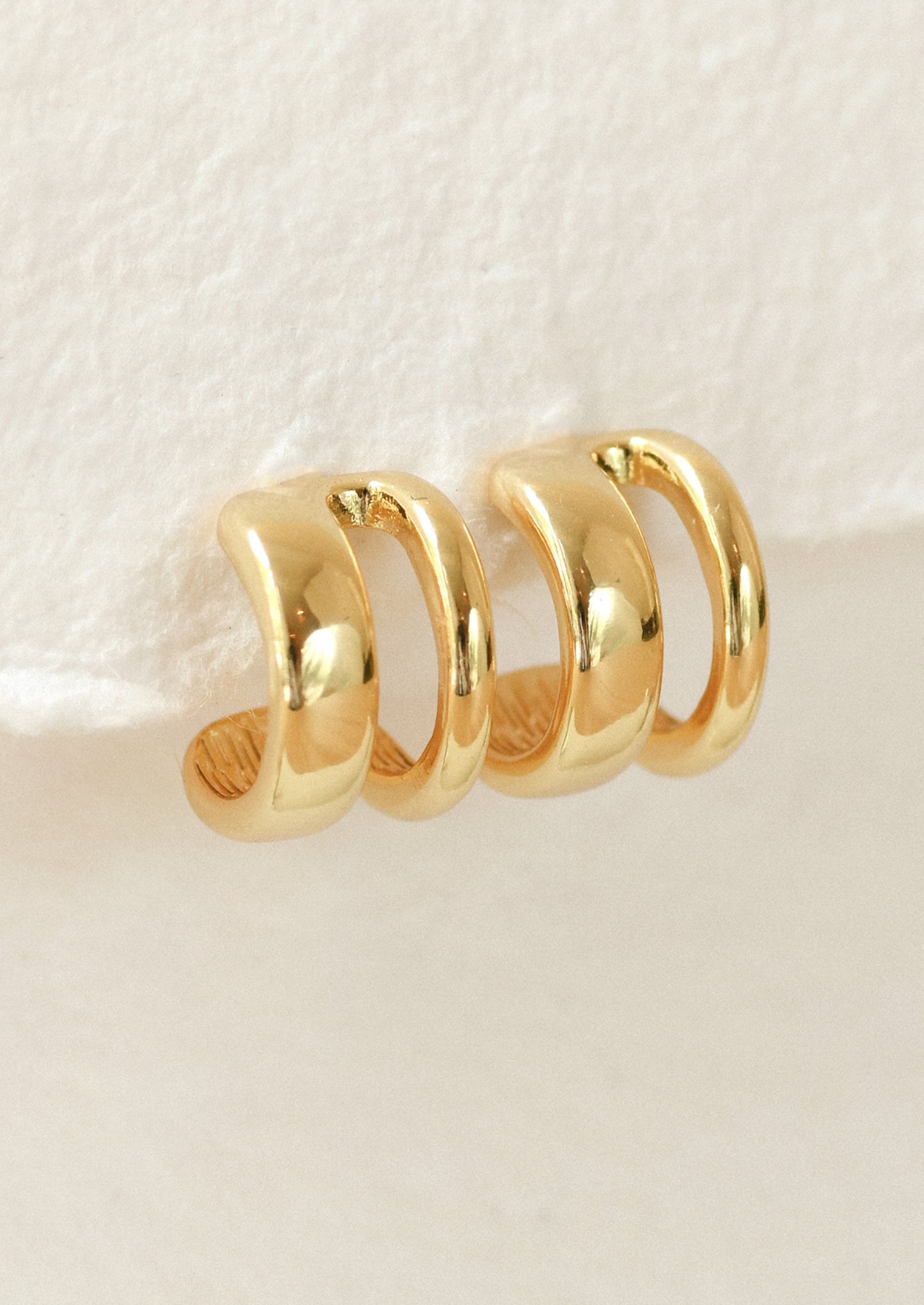 A pair of double cuff hoop earrings.