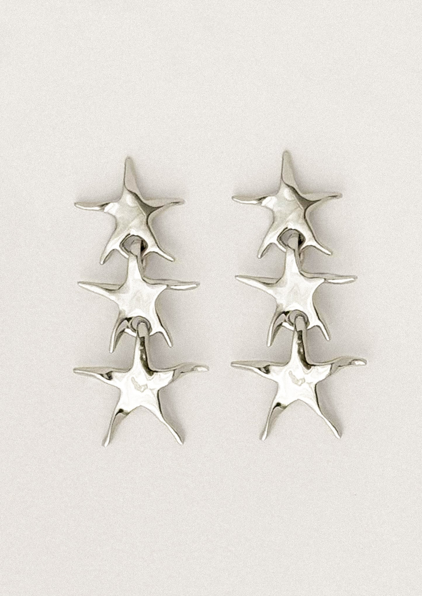 A pair of stacked star earrings in silver.