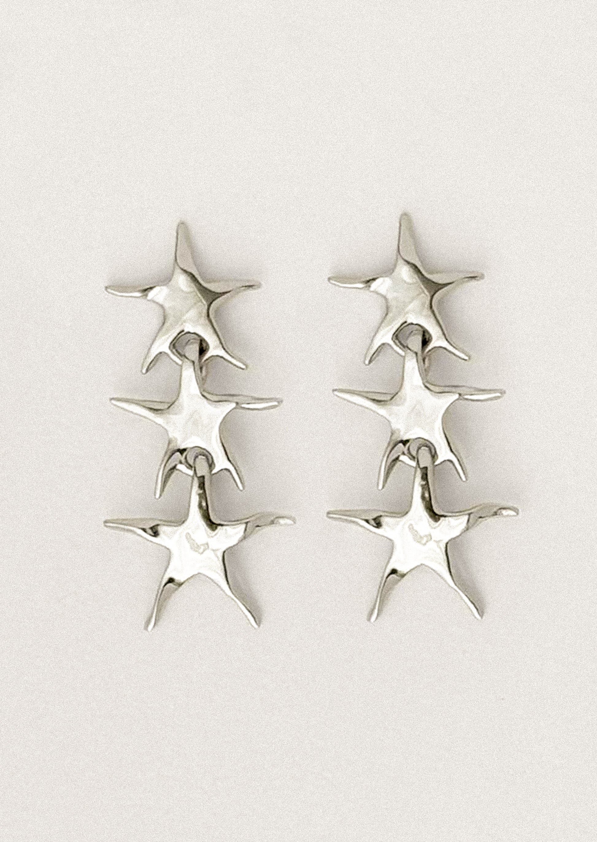 A pair of stacked star earrings in silver.