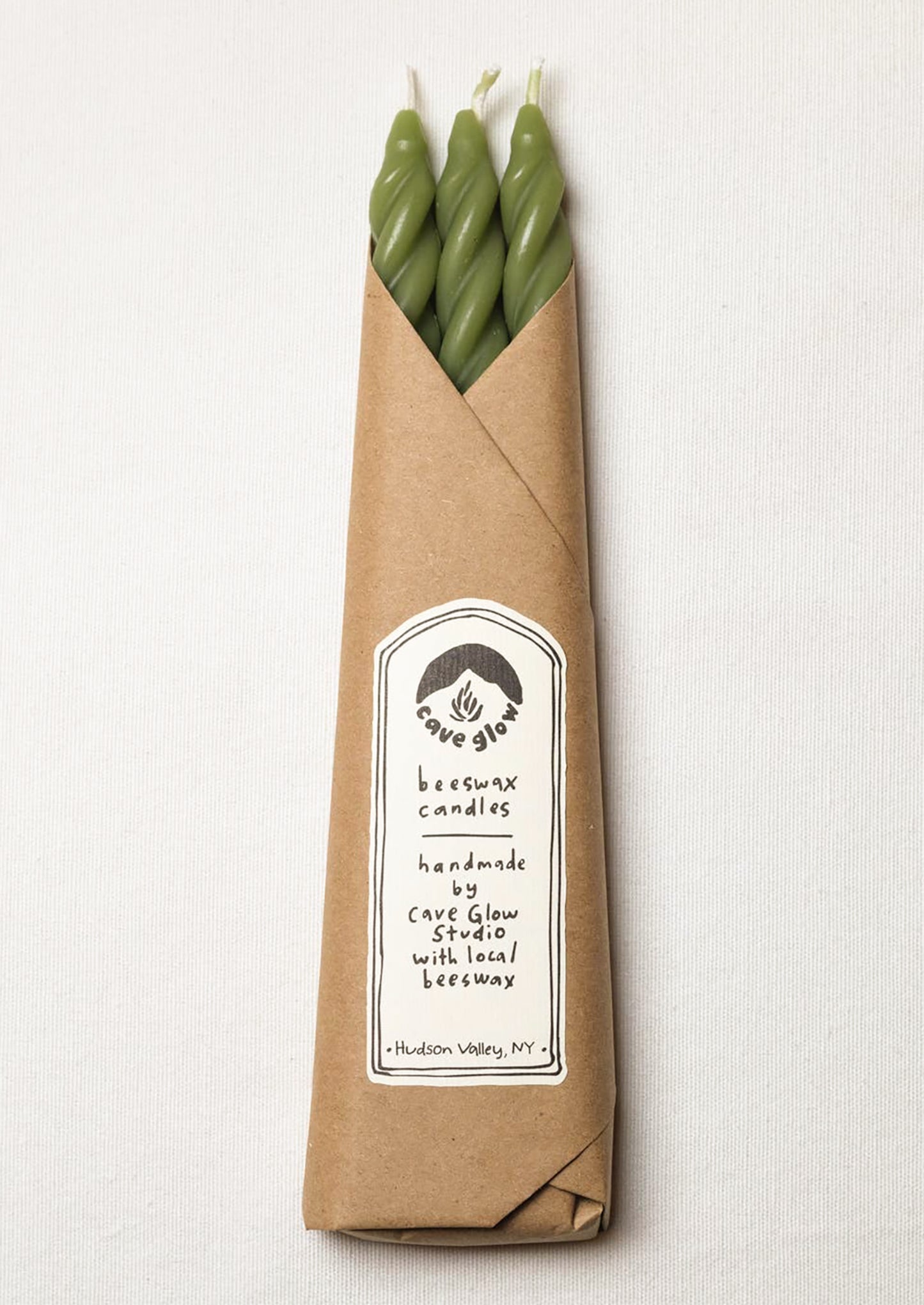 A set of three spiral textured taper candles in grass green color.