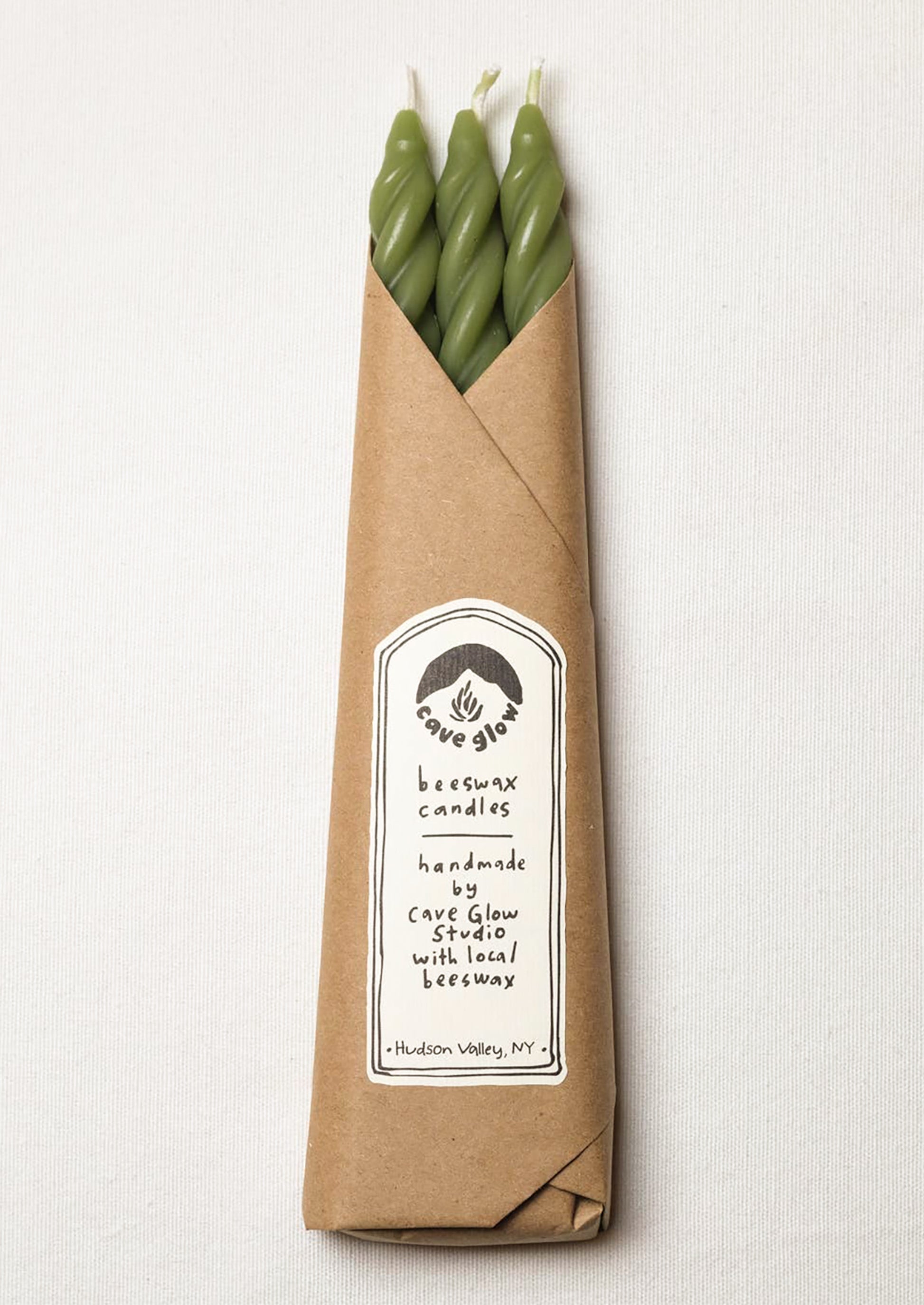 A set of three spiral textured taper candles in grass green color.