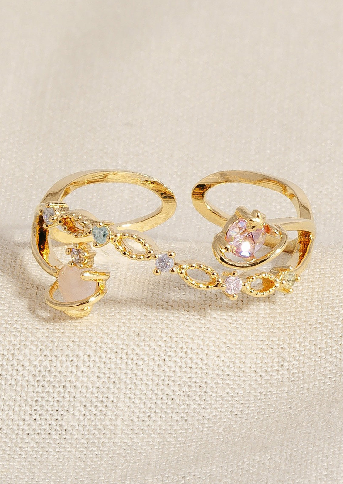 A ring with pastel colored crystals and planet design.